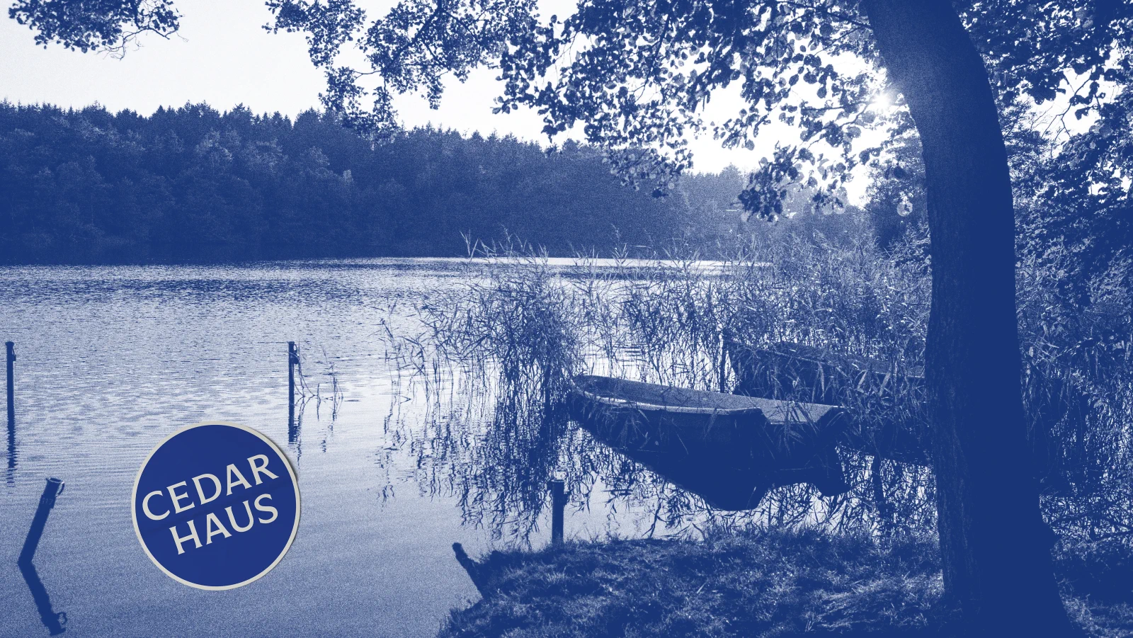 Duotone blue lake scene with Cedar Haus circular badge