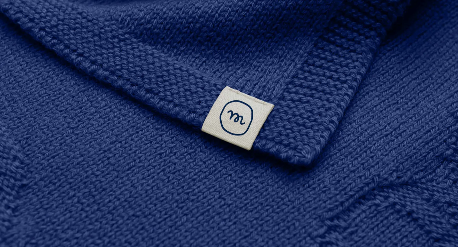 Woven minter label on blue merino wool knitwear