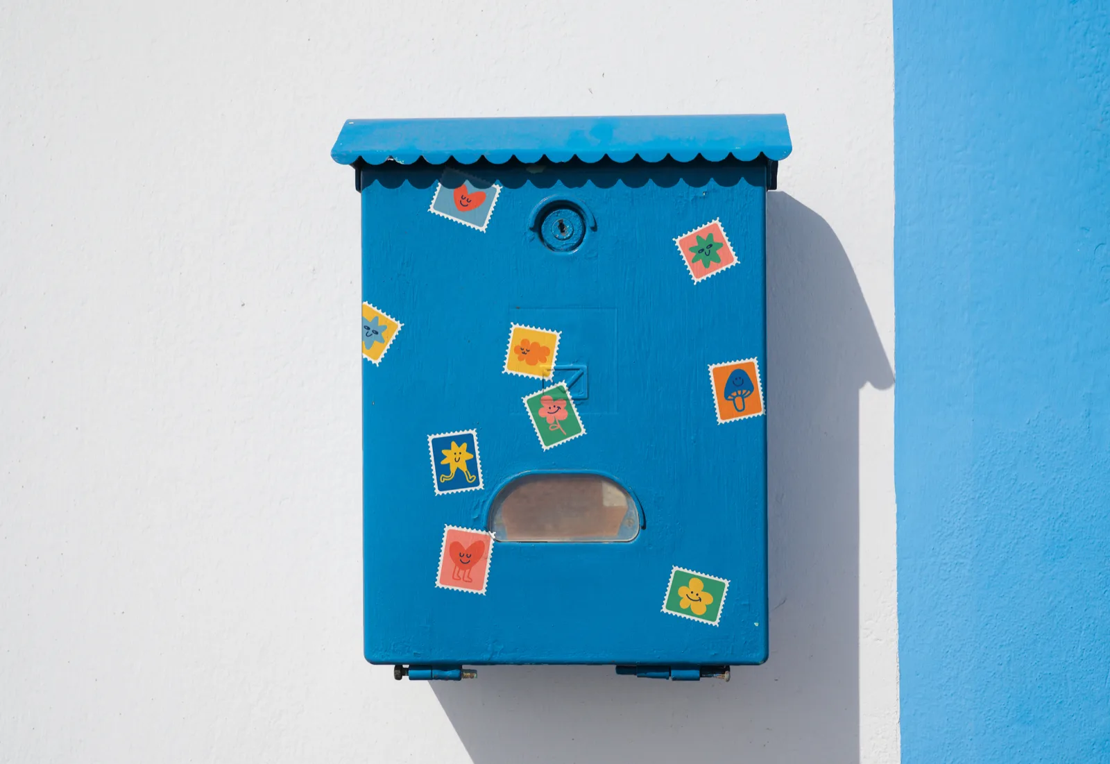 Blue letterbox with minter stamp stickers
