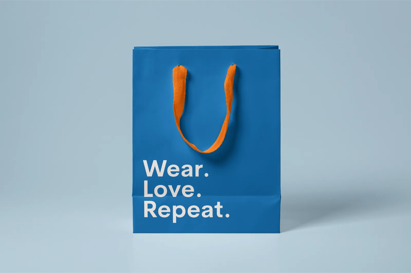 Blue paper shopping bag - Wear. Love. Repeat.